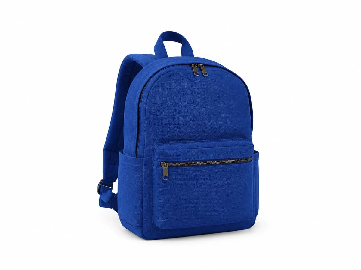 A blue canvas backpack photographed on a white background